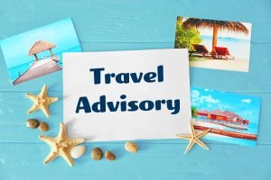 Images of a tropical island and scattered shells and sea stars with a card that says “Travel Advisory”