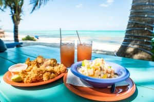 Conch fritters next to conch ceviche served alongside punch